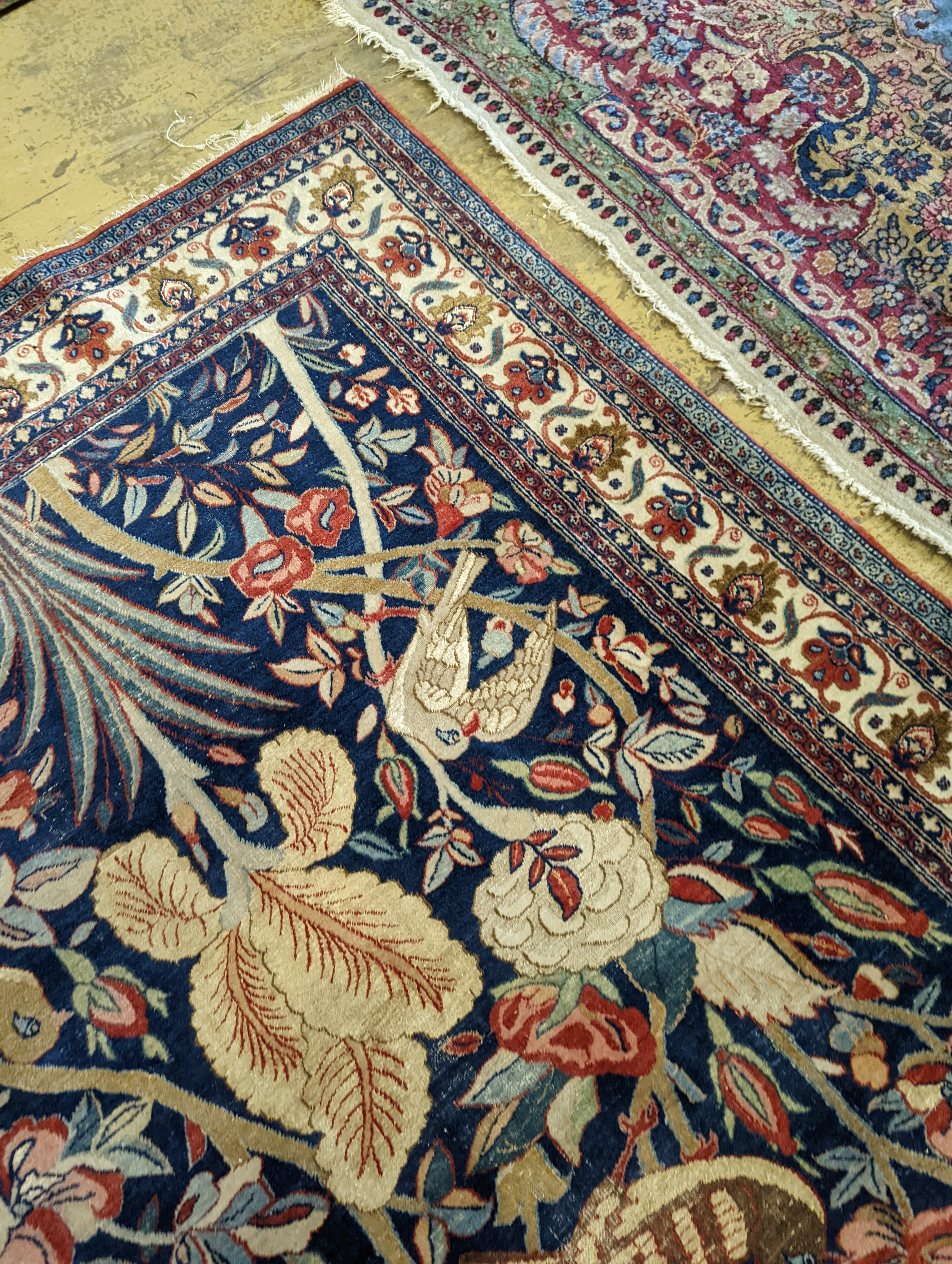 A Kirman blue ground rug woven with birds amongst flowering branches, 205 x 136cm